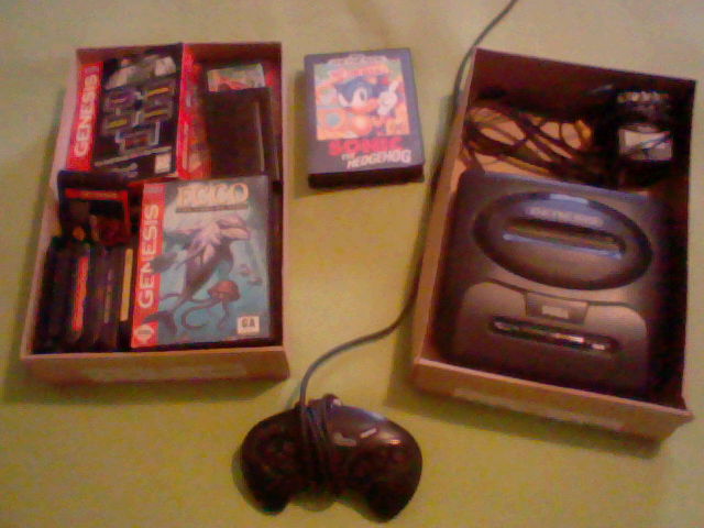 A Sega Genesis and some games in boxes