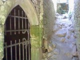 A spooky stone door into a dark room and the rough shape of the stairs to the second level