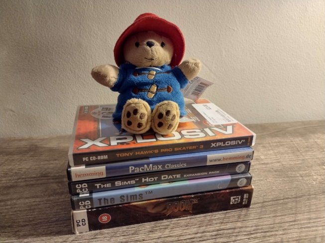 Tiny Paddington atop the stack of PC games I also bought in Wales