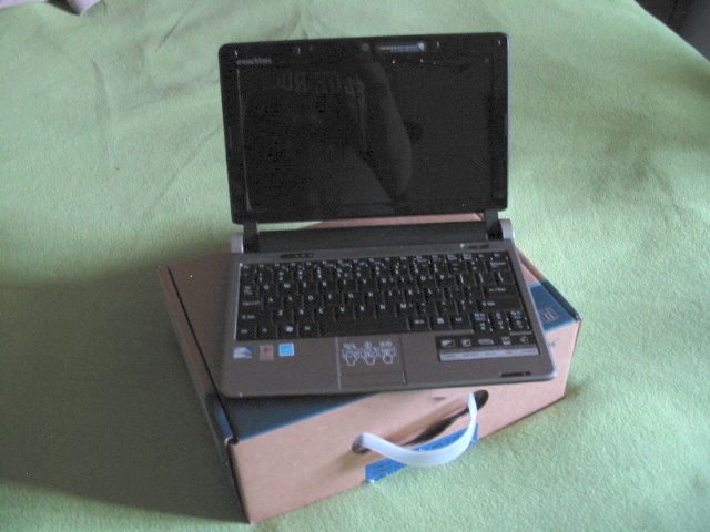 The eMachines laptop on top of its box