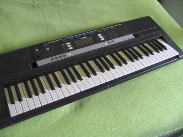 The PSR-E243 sitting across my bed