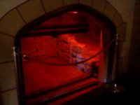 A fireplace bathed in red light